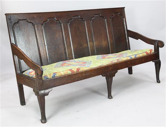 An 18th century carved oak settle, W. 6ft. D. 2ft 3in. H 3ft 4in.